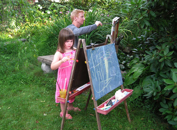 Photo of Robert and his daughter Sofia painting by the pond